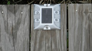 low wattage solar lighting installed along a long fixed pier
